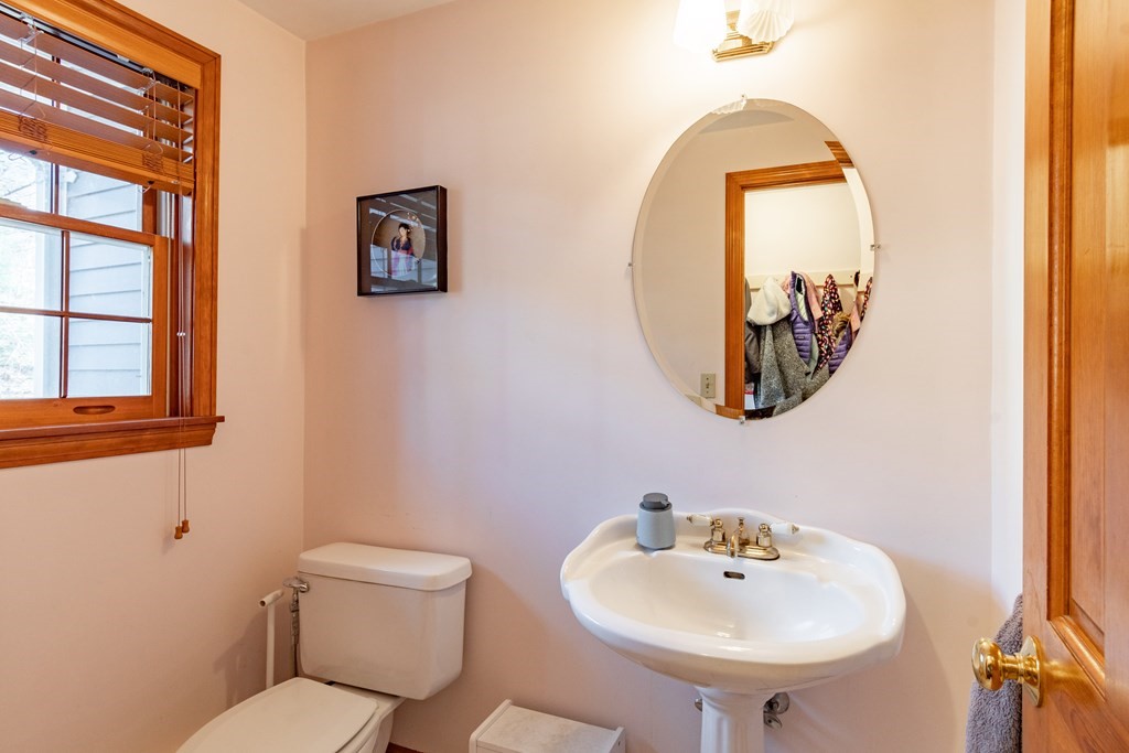 38 Westview Road Brookline, NH 03033 - Photo 10 of 28 a bathroom with a toilet a sink and a mirror