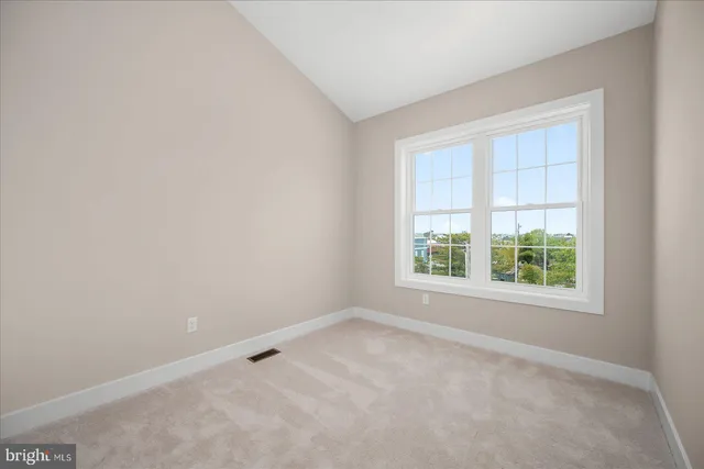 a view of an empty room and closet area