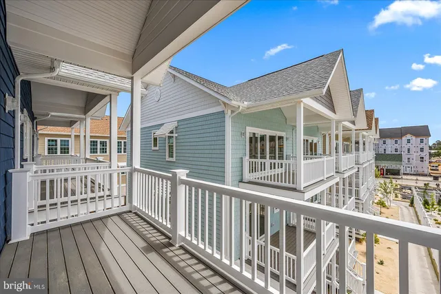 a view of a large building with a big yard and large trees