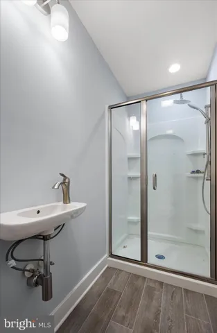 a view of a bathroom with a shower and a sink