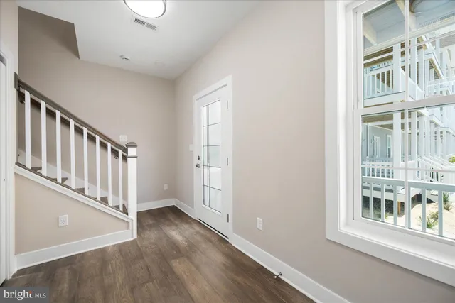 a view of an entryway with wooden floor