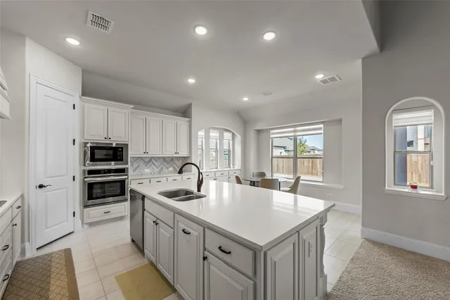 a dining room with furniture a chandelier and wooden floor