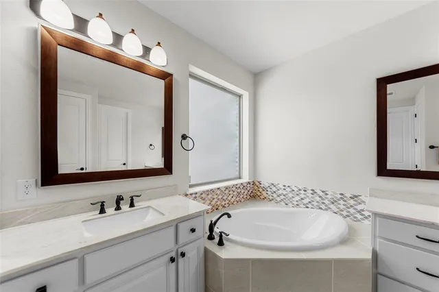 a spacious bathroom with a bathtub and a shower