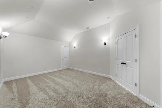 a view of empty room with windows and ceiling fan