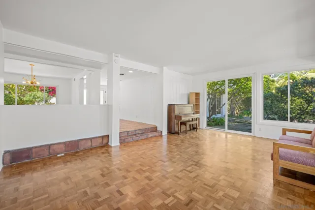 a view of an empty room with glass door