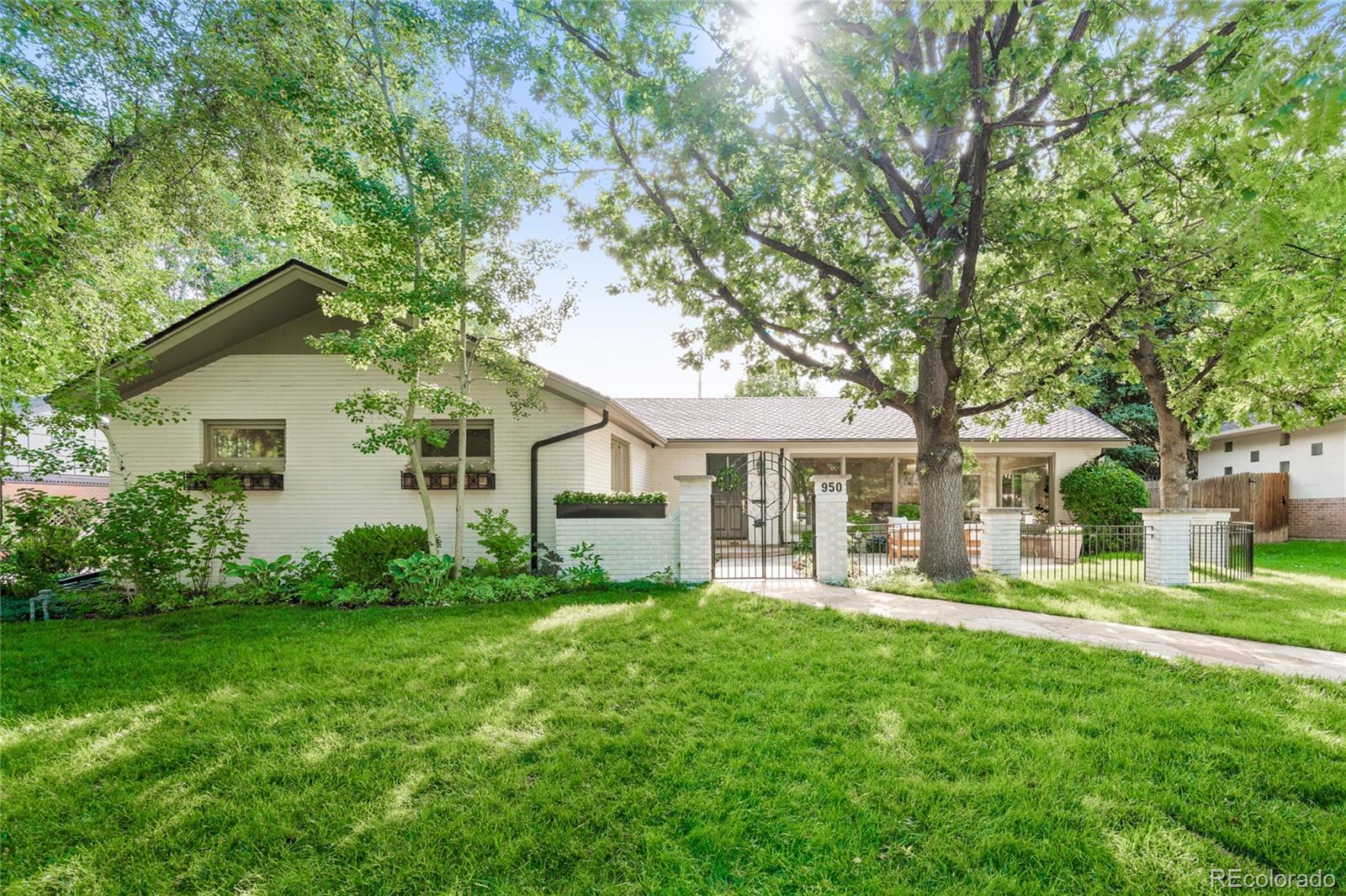 950 South Monroe Street Denver, CO 80209 - Photo 2 of 39 a front view of a house with a garden