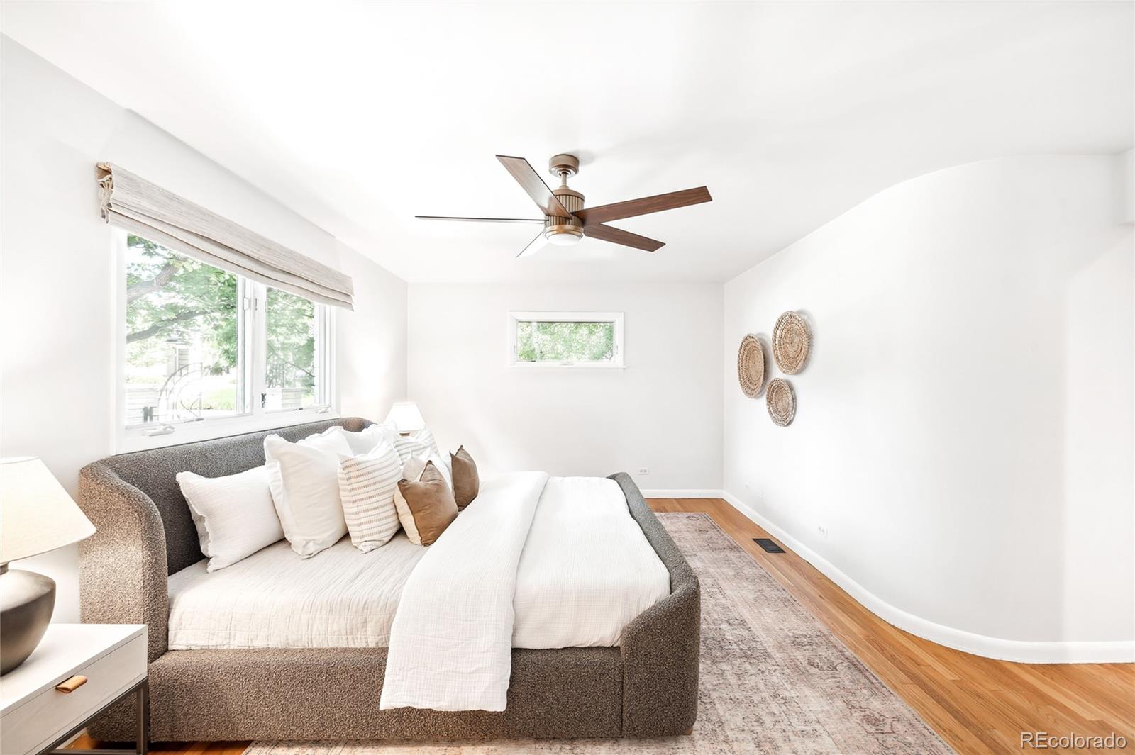 950 South Monroe Street Denver, CO 80209 - Photo 22 of 39 a bed room with a bed and a ceiling fan