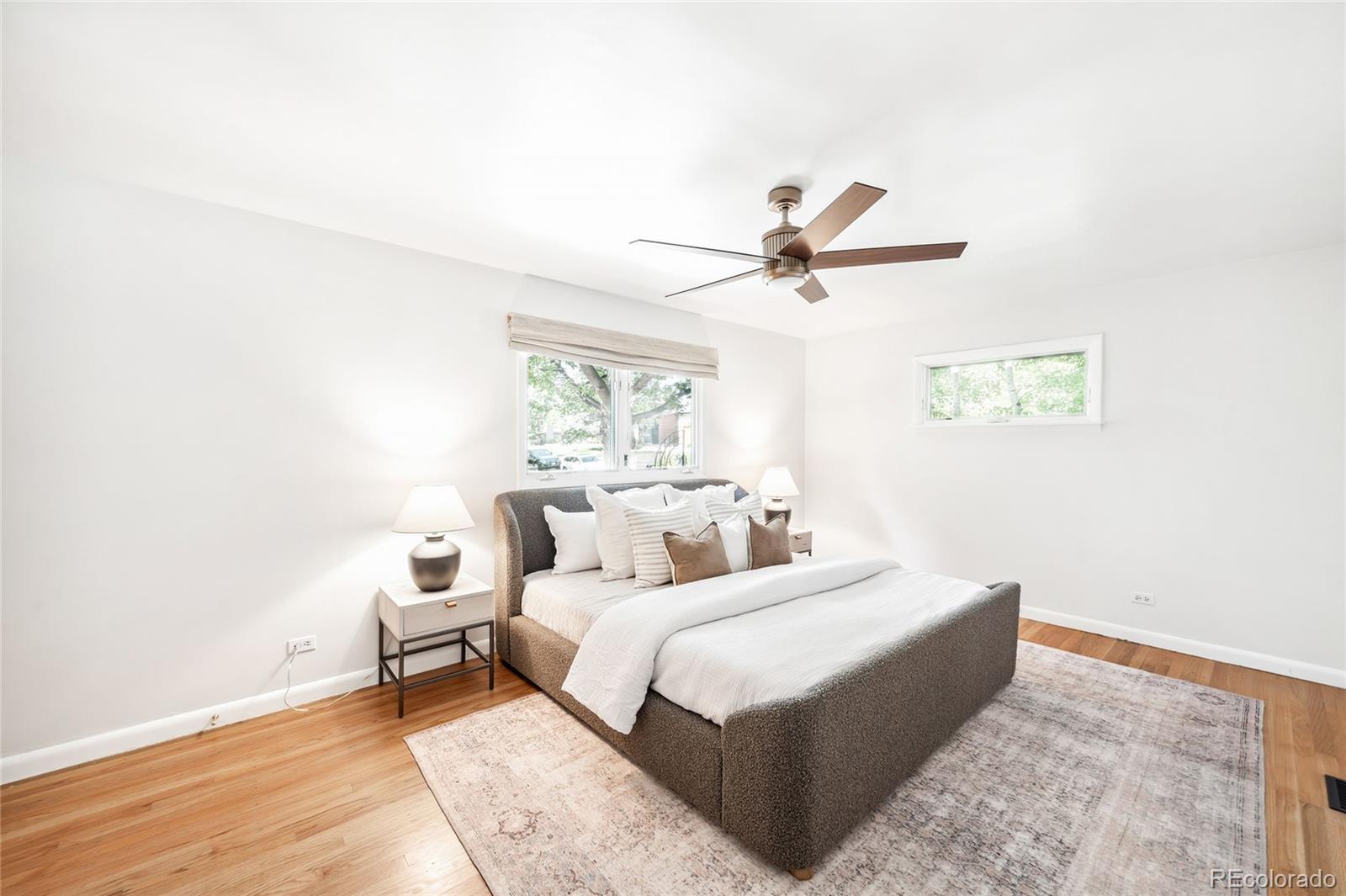 950 South Monroe Street Denver, CO 80209 - Photo 23 of 39 a bedroom with a bed and a chandelier