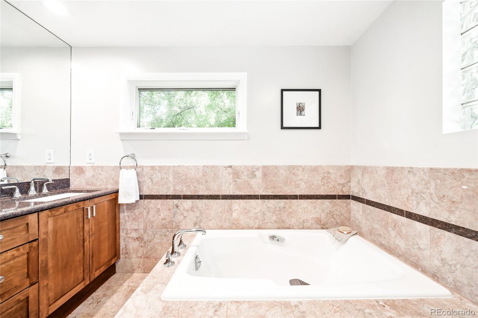 950 South Monroe Street Denver, CO 80209 - Photo 25 of 39 a bathroom with a bathtub and a sink