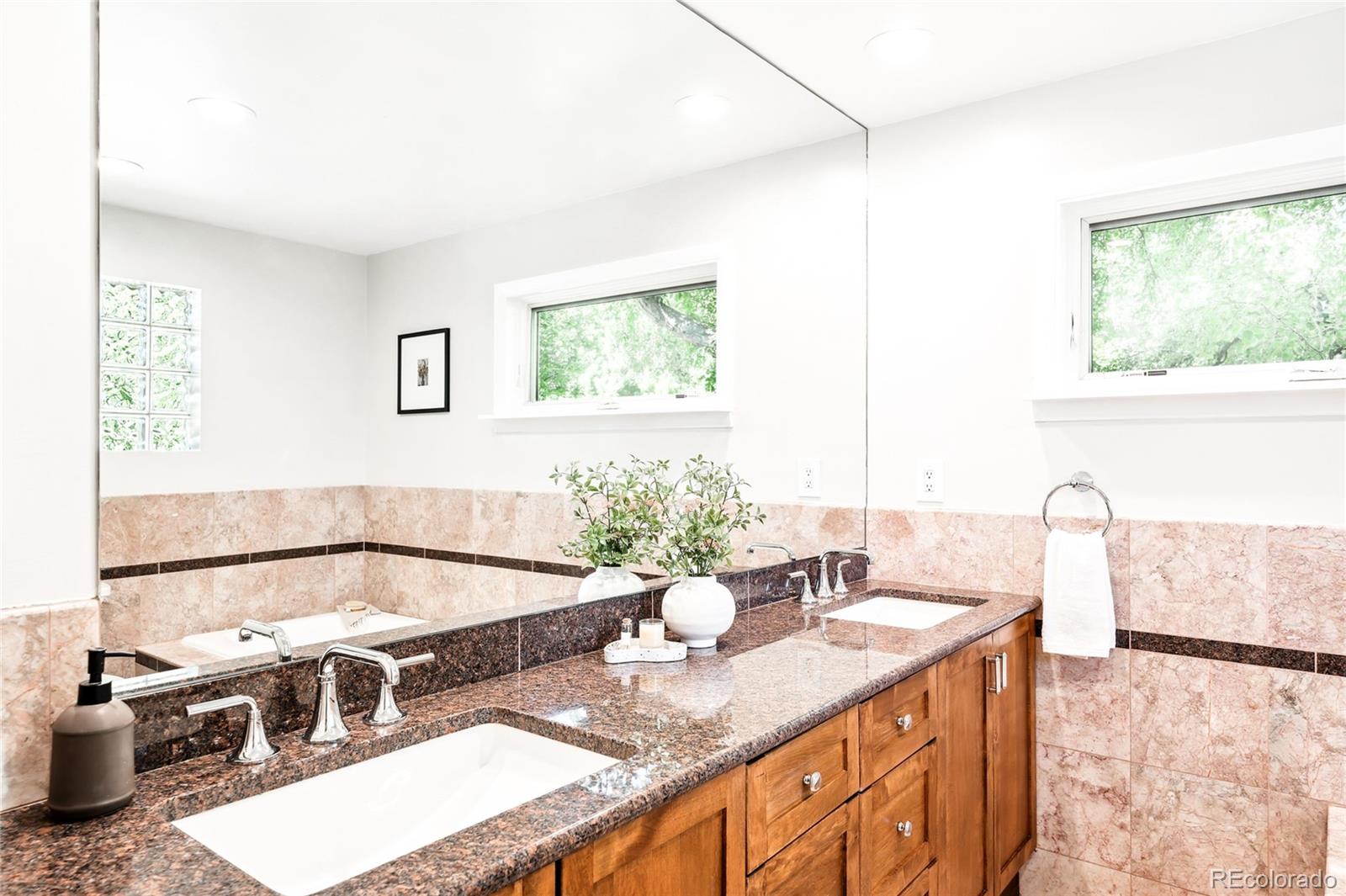 950 South Monroe Street Denver, CO 80209 - Photo 26 of 39 a bathroom with a granite countertop sink and a large mirror