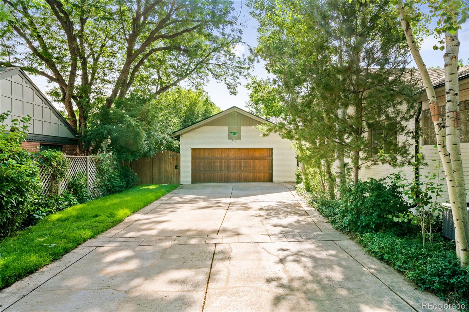 950 South Monroe Street Denver, CO 80209 - Photo 39 of 39 a front view of a house with a yard and trees