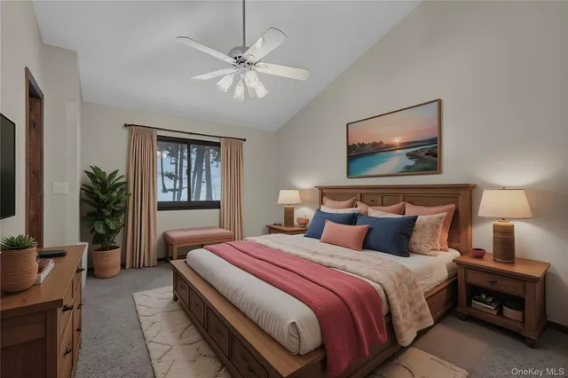 an empty room with a chandelier fan and windows