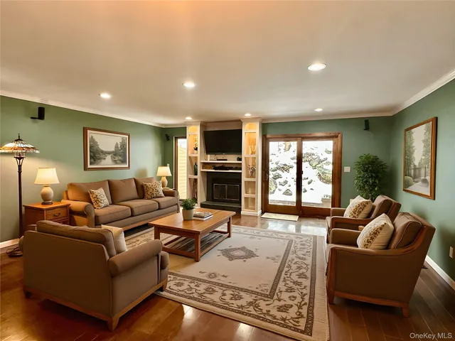a living room with furniture fireplace and a window