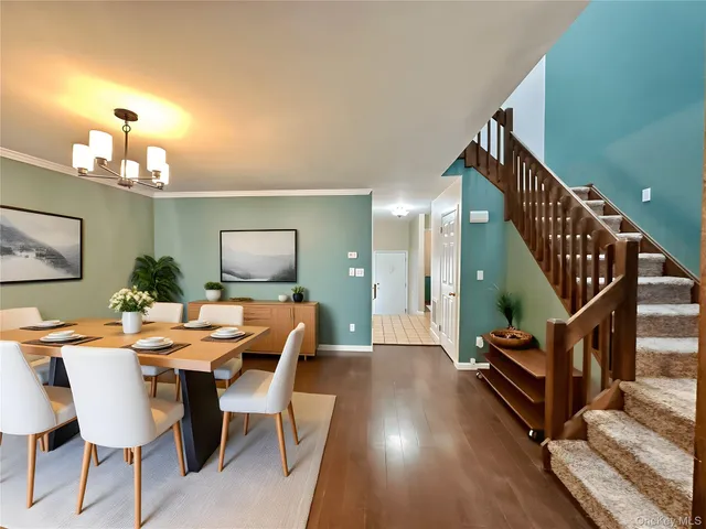 a view of a dining room with furniture and a chandelier