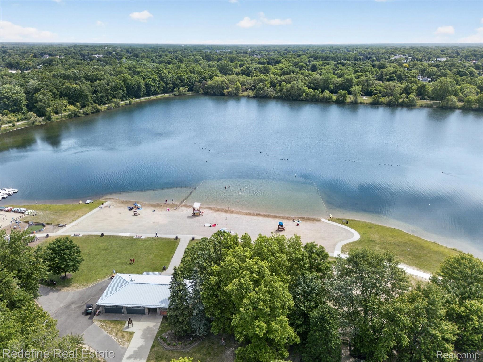 2976 Andlaur Drive Rochester, MI 48307 - Photo 55 of 60 Expansive lakefront setting with a sandy beach and designated swimming area