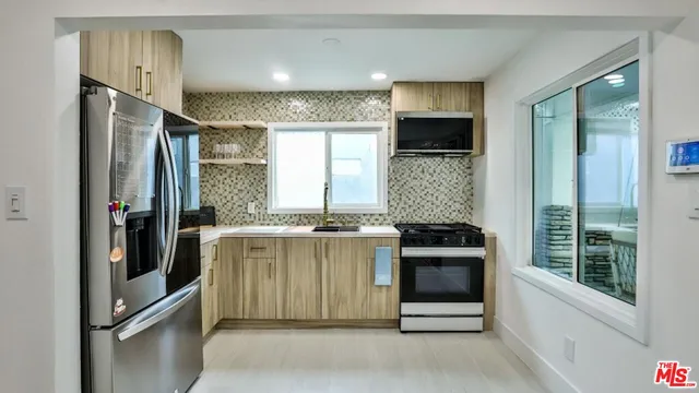 a kitchen with a stove and refrigerator