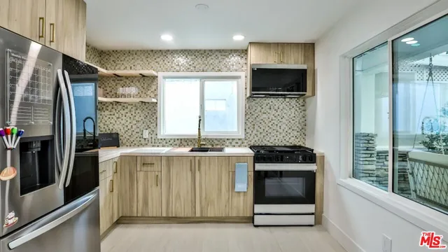 a kitchen with stainless steel appliances a stove and a refrigerator