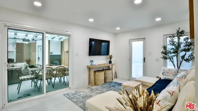 a bedroom with furniture and a flat screen tv