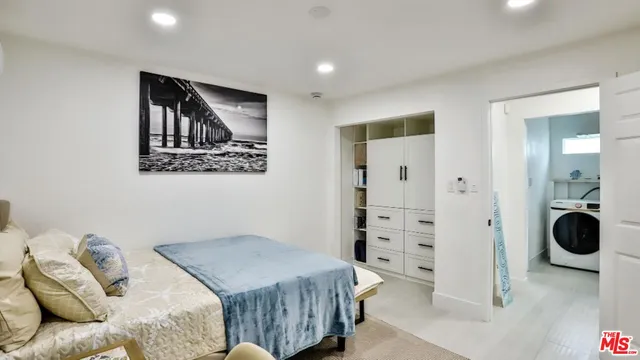 a bedroom with a bed and walk in closet