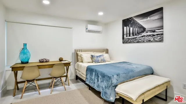 a bedroom with a bed and a table in it