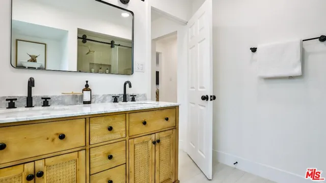 a bathroom with a double vanity sink mirror and