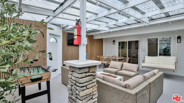 a outdoor living space with furniture and a fireplace