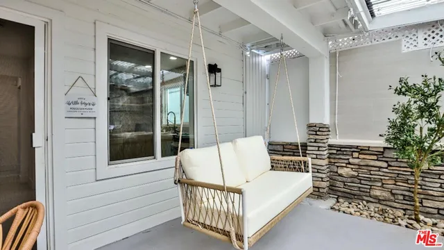 a view of balcony with furniture