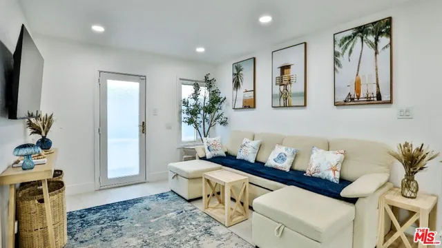 a living room with furniture and a potted plant