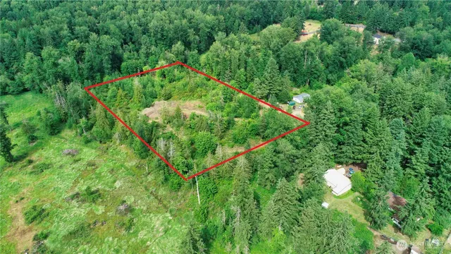 a backyard of a house with a yard and outdoor seating