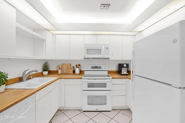 a kitchen with stainless steel appliances a sink and cabinets