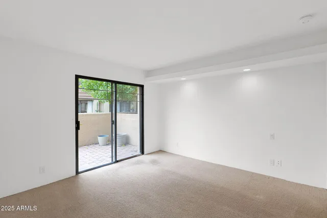 a view of an empty room with glass door