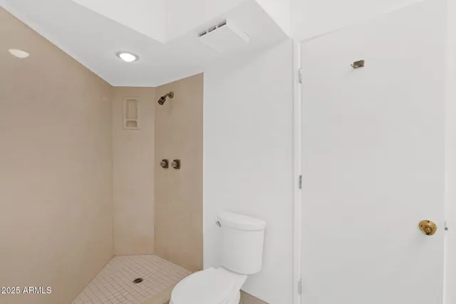 a bathroom with a shower a toilet and a sink