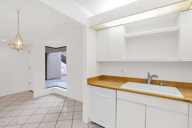 a room with a sink and cabinets