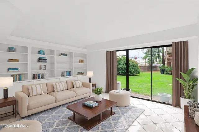a living room with furniture and a floor to ceiling window