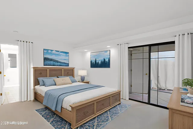 a bedroom with a bed and a night stand