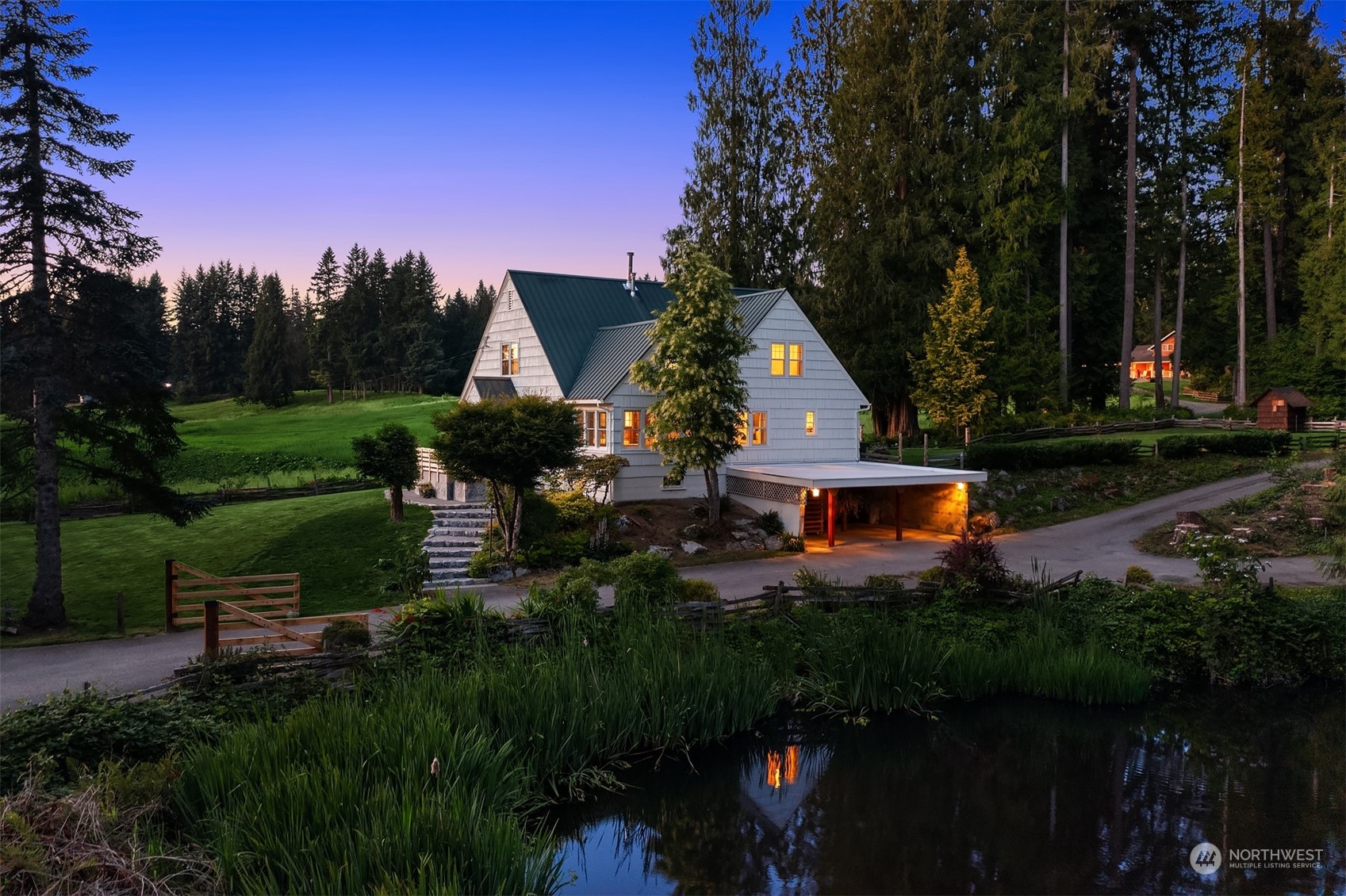 a view of backyard with table and chairs a fire pit and plants