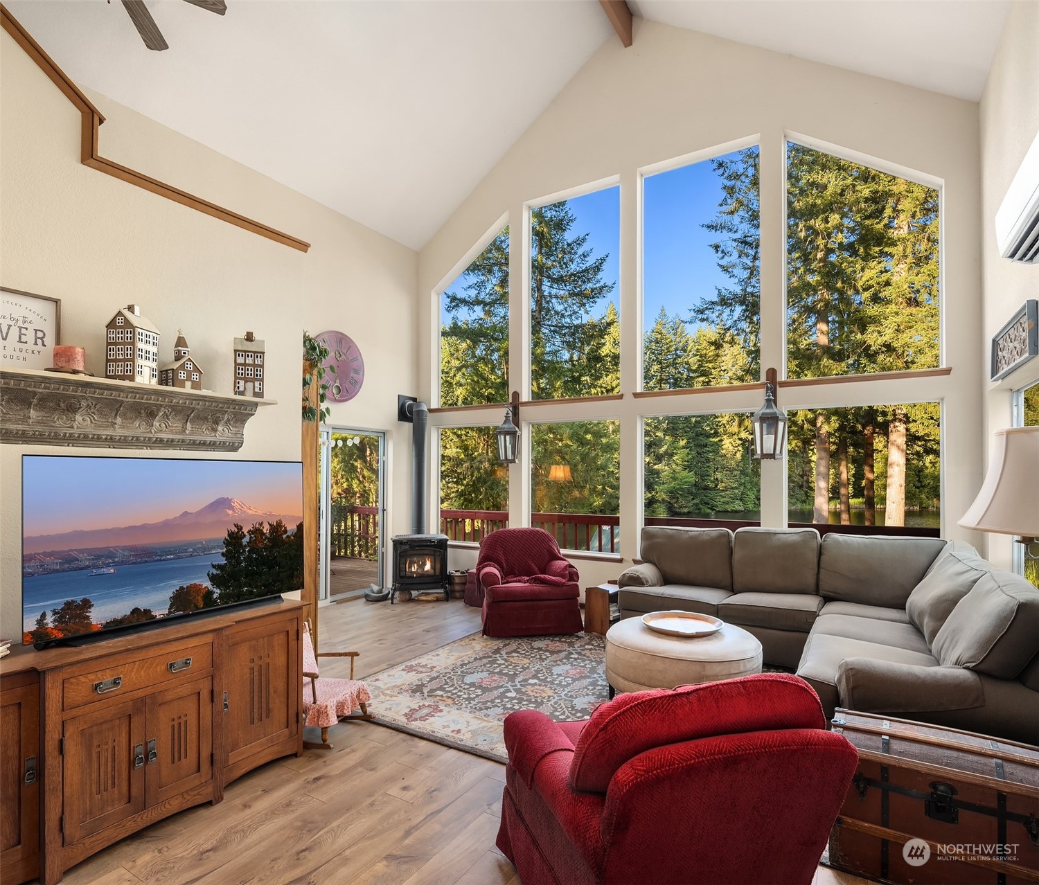 7715 Robe Menzel Road Granite Falls, WA 98252 - Photo 28 of 38 a living room with furniture a flat screen tv and a floor to ceiling window
