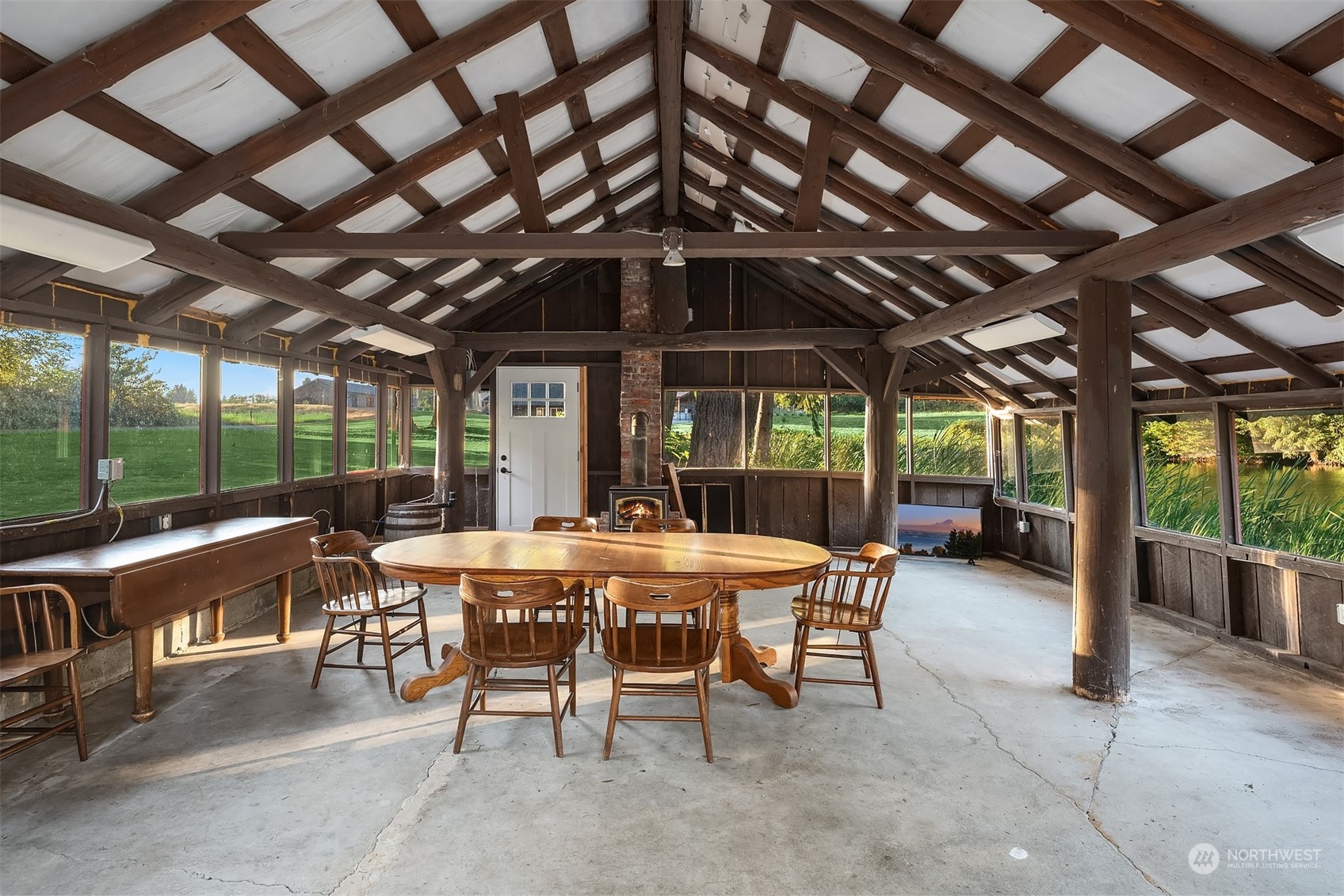 7715 Robe Menzel Road Granite Falls, WA 98252 - Photo 36 of 38 a view of a patio with a table and chairs under a large umbrella with a big yard