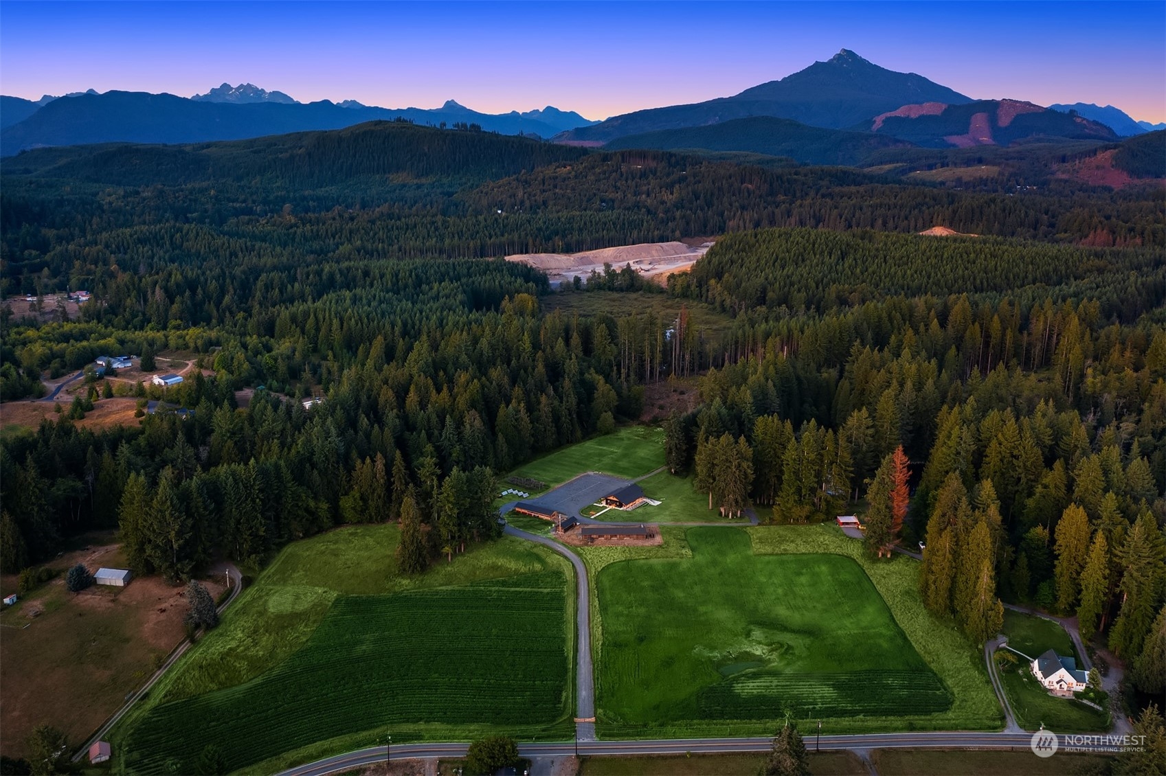 7715 Robe Menzel Road Granite Falls, WA 98252 - Photo 4 of 38 a view of a lush green hillside and a building in the background