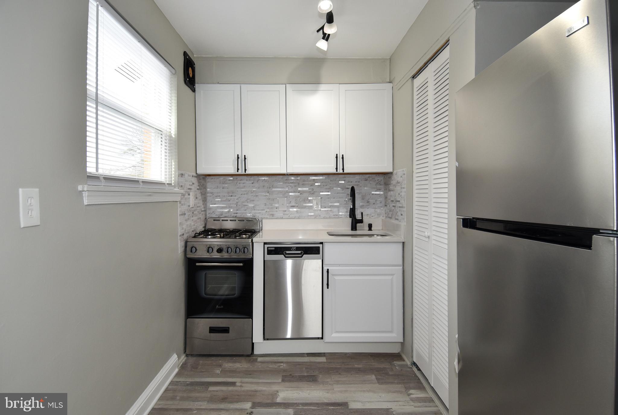 8208 Bellefonte Lane, Unit 2 Clinton, MD 20735 - Photo 18 of 38 a kitchen with a refrigerator sink and stove