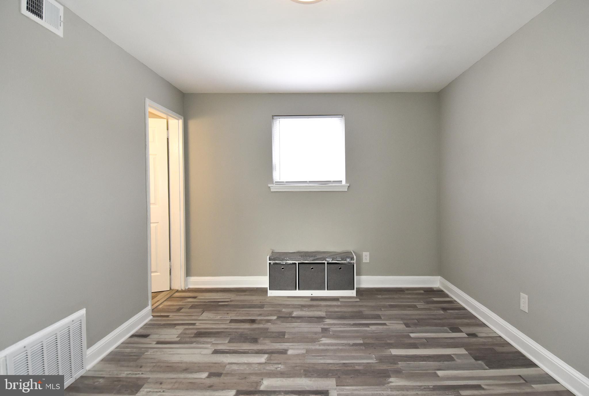 8208 Bellefonte Lane, Unit 2 Clinton, MD 20735 - Photo 22 of 38 a view of a livingroom with wooden floor and a window