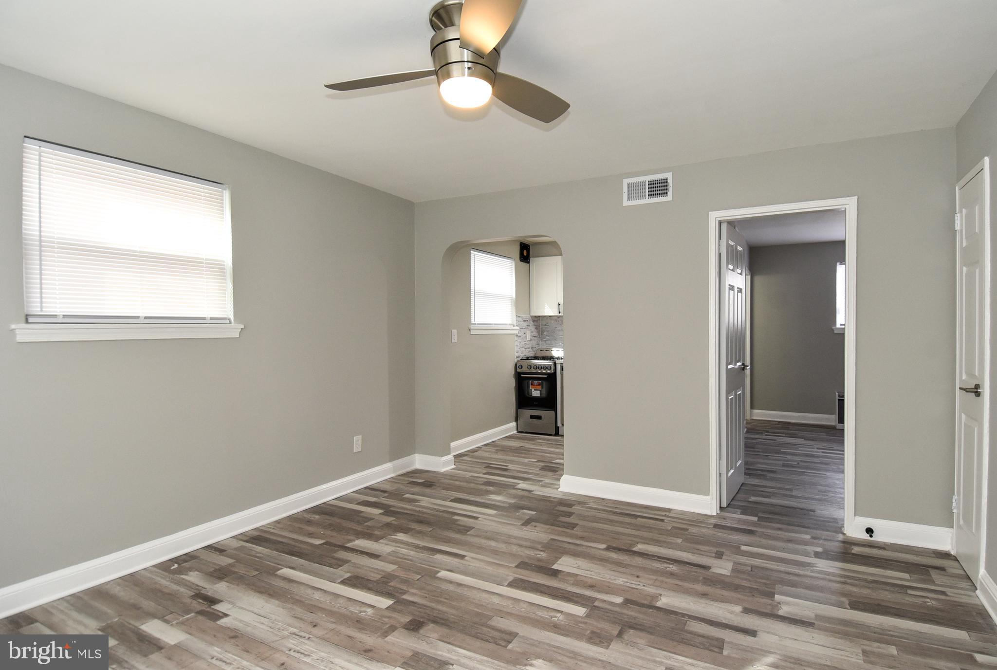 8208 Bellefonte Lane, Unit 2 Clinton, MD 20735 - Photo 3 of 38 a view of an empty room with wooden floor and a window