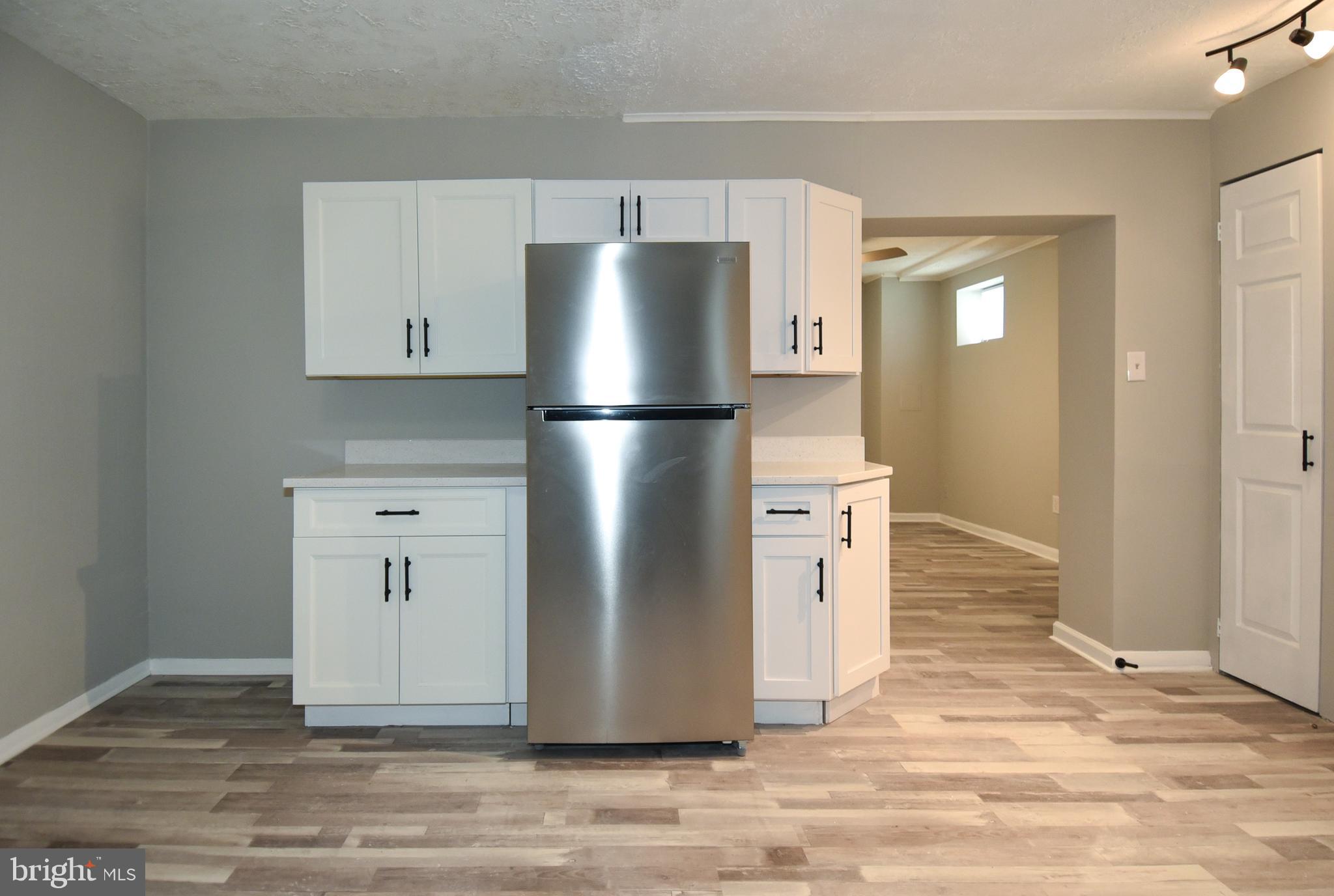 8208 Bellefonte Lane, Unit 2 Clinton, MD 20735 - Photo 34 of 38 a view of kitchen with refrigerator cabinets and wooden floor