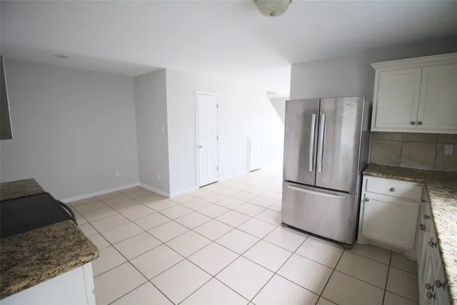 a kitchen with a sink a stove and cabinets