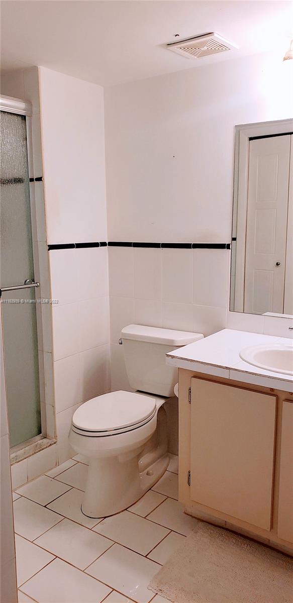 370 Racquet Club Road, Unit 103 Weston, FL 33326 - Photo 14 of 16 a bathroom with a sink a toilet and shower