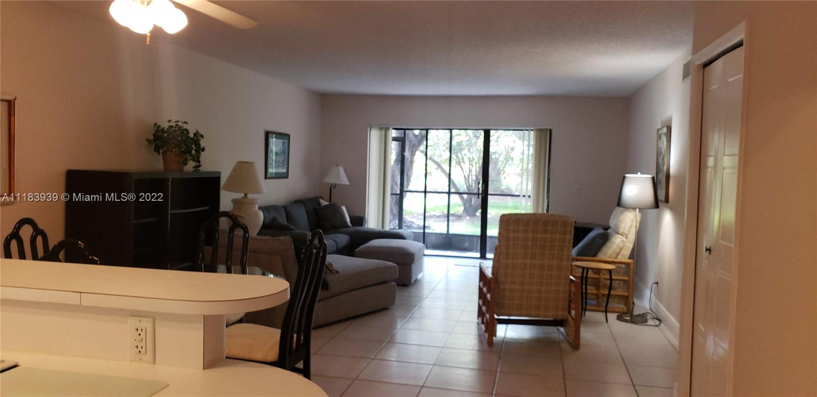 370 Racquet Club Road, Unit 103 Weston, FL 33326 - Photo 6 of 16 a living room with furniture and a large window