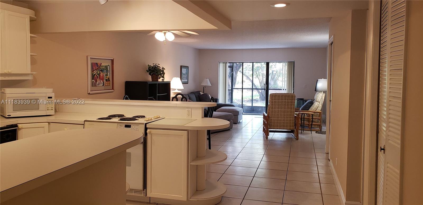 370 Racquet Club Road, Unit 103 Weston, FL 33326 - Photo 7 of 16 a kitchen with a sink appliances and cabinets