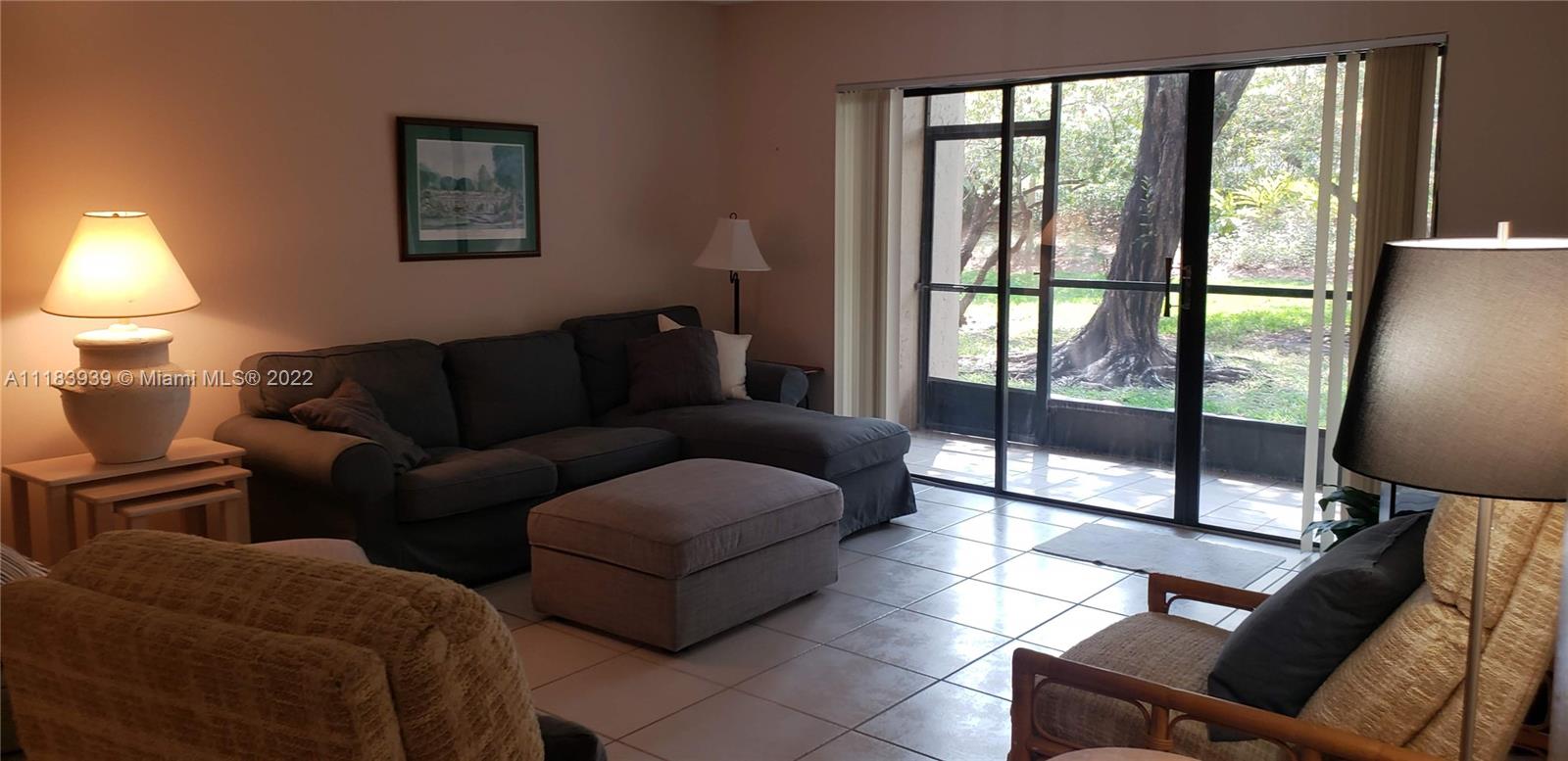 370 Racquet Club Road, Unit 103 Weston, FL 33326 - Photo 8 of 16 a living room with furniture and a window