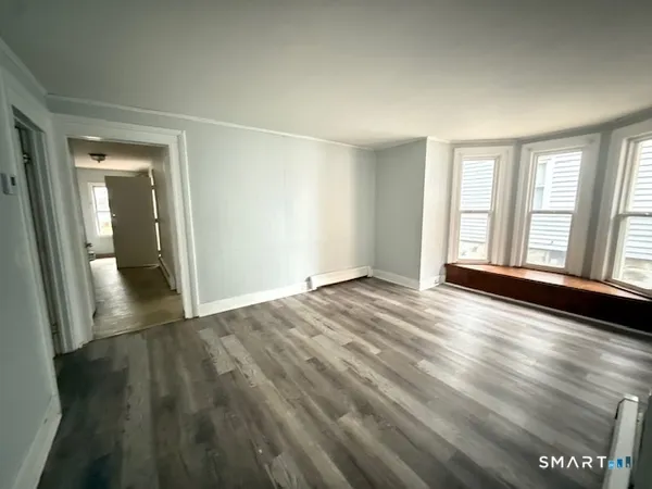 wooden floor in an empty room with a window