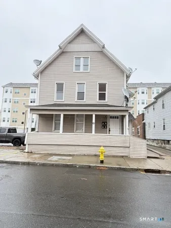 a front view of a house with a street